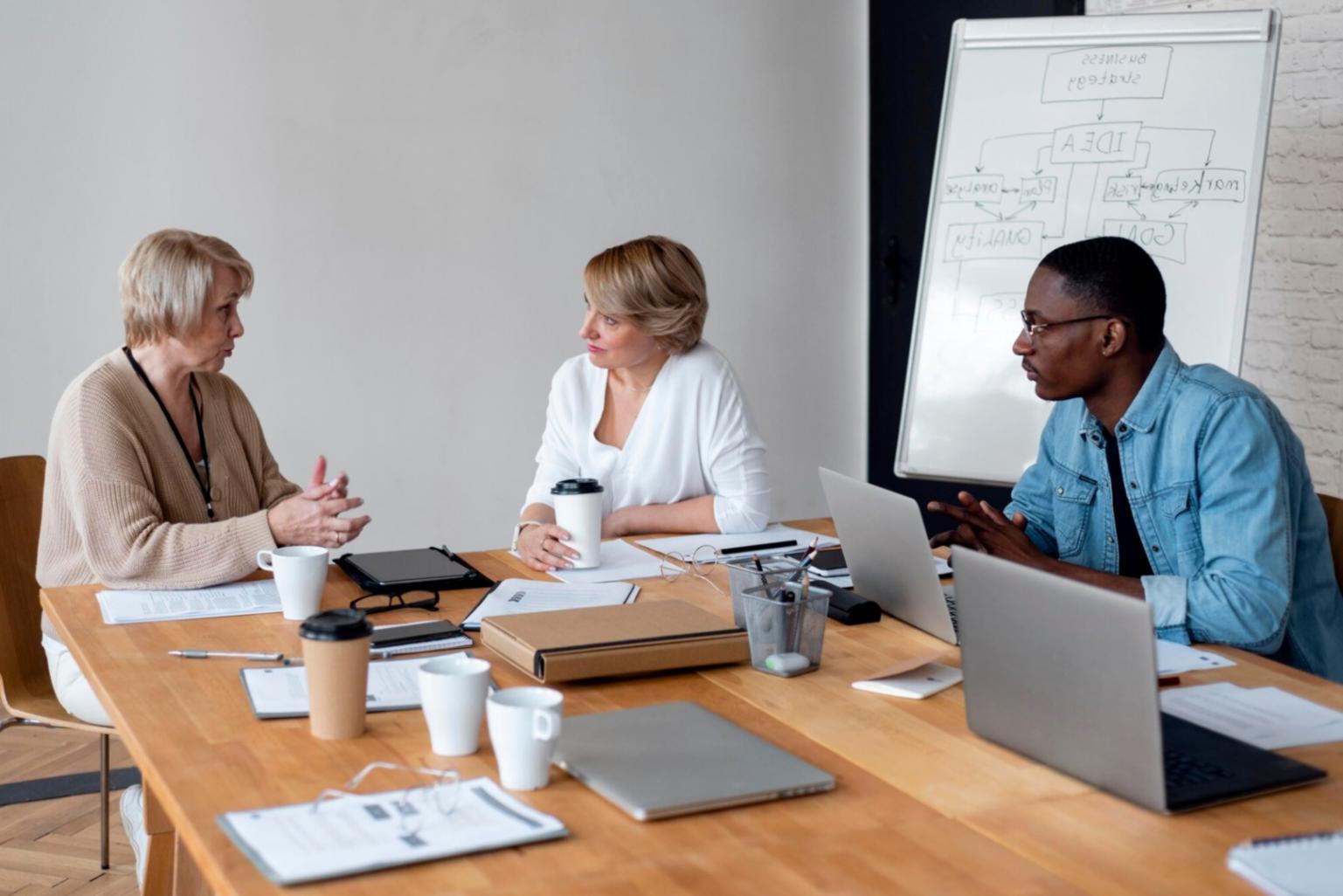 Students analyzing stock market charts and data on multiple screens during a practical trading session