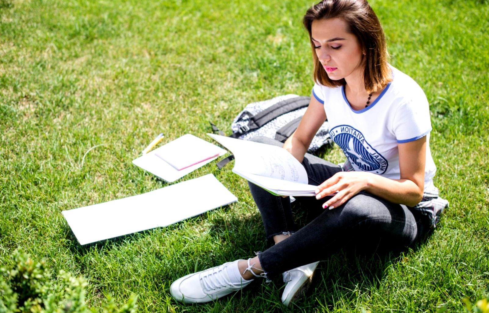 Students collaborating on market analysis using multiple screens displaying real-time trading data and charts